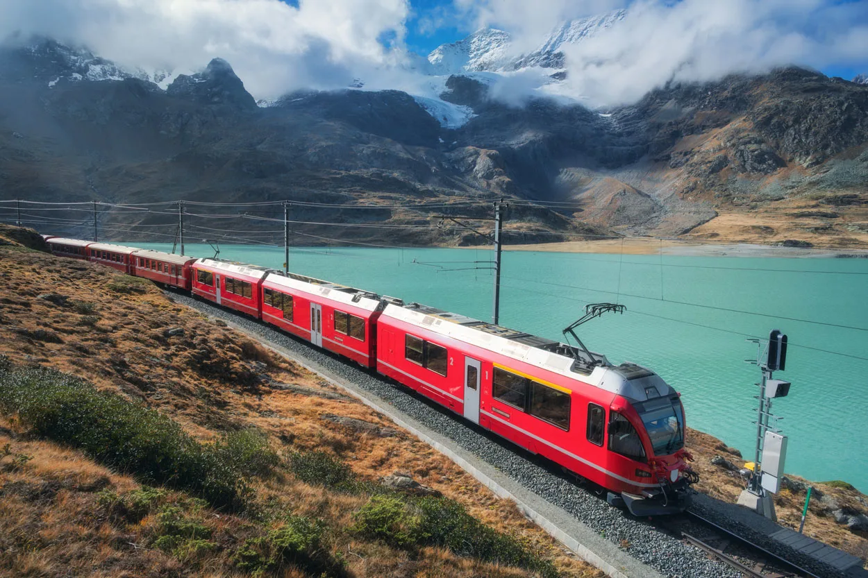 red train is moving along railway in swiss alps mo 2025 03 18 21 28 42 utc2.webp